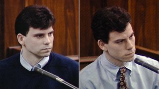 Lyle and Erik Menendez sit at the witness stand in front of a microphone during one of their trials.