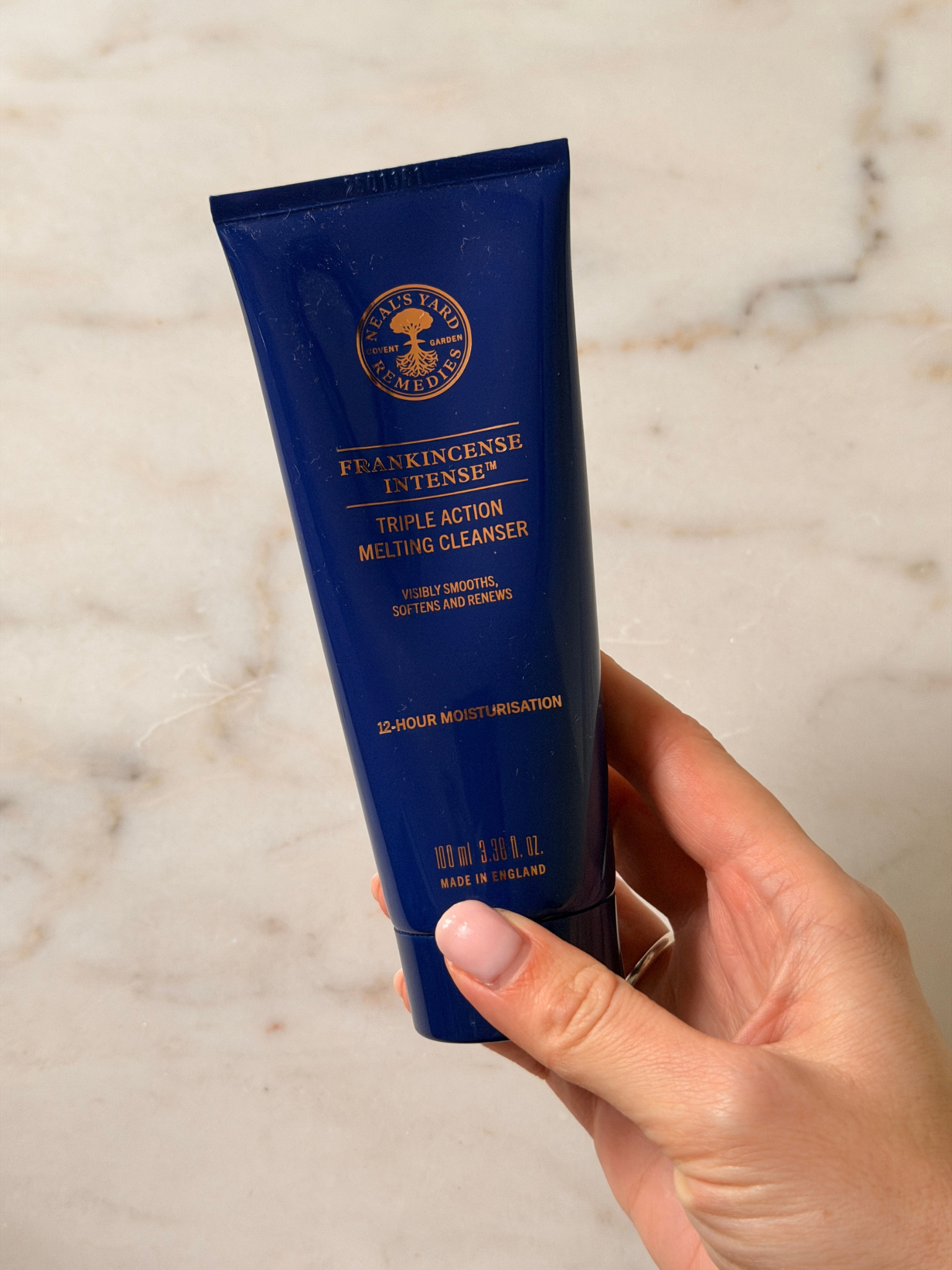 Freelance beauty editor Grace Day holding a tube of neals yard cleanser