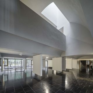Junshan Cultural Center lobby with white ceiling and walls and black floor