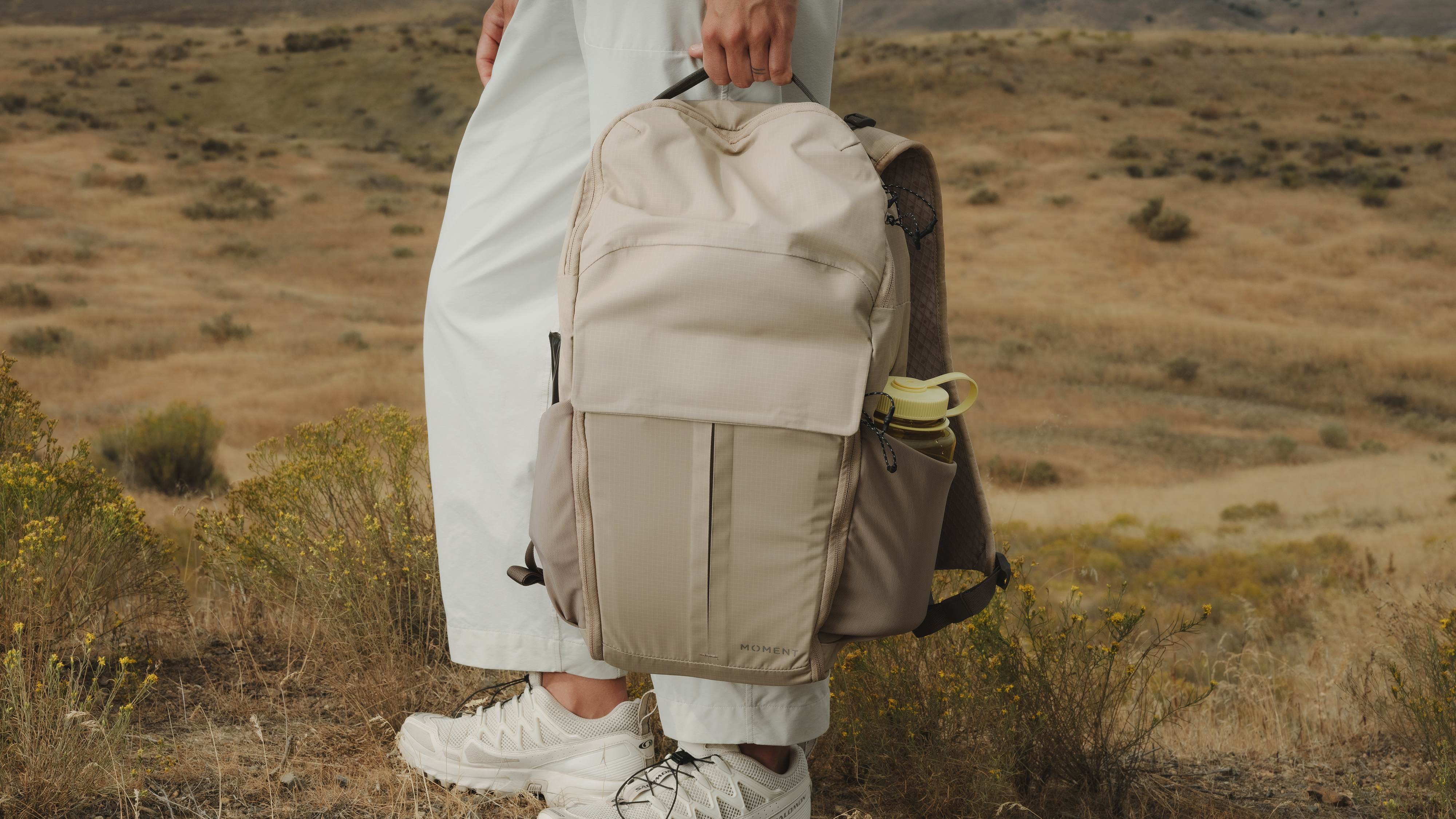 The Moment Sequence backpack being used by a photographer