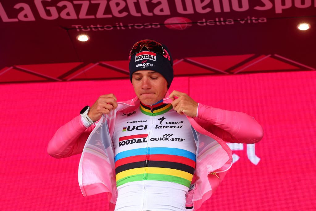Remco Evenepoel dons the maglia rosa after winning the stage 9 time trial