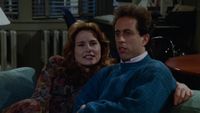 Jennifer Coolidge with Jerry Seinfeld sitting on a counch on Seinfeld