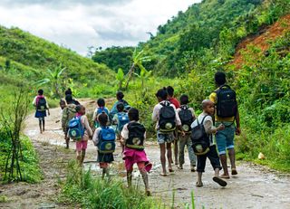 Children on the way to school, Betsimisaraka people ('the many inseparables'), the largest ethnic group on the eastern coast of Madagascar, Ambavaniasy, Madagascar.