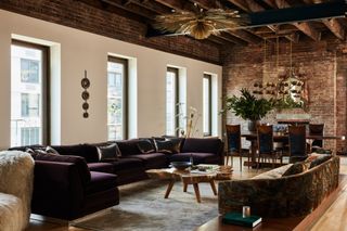 A living room with exposed brickwork and wooden beams