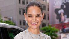 Katie Holmes in navy blue cargo pants nad feathery print top