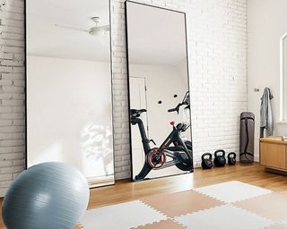Two Cordero full length mirrors with exercise balls and exercise bike in reflection