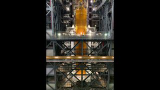 The core stage of the Space Launch System rocket has been lowered onto the launcher platform in between the two solid rocket boosters.