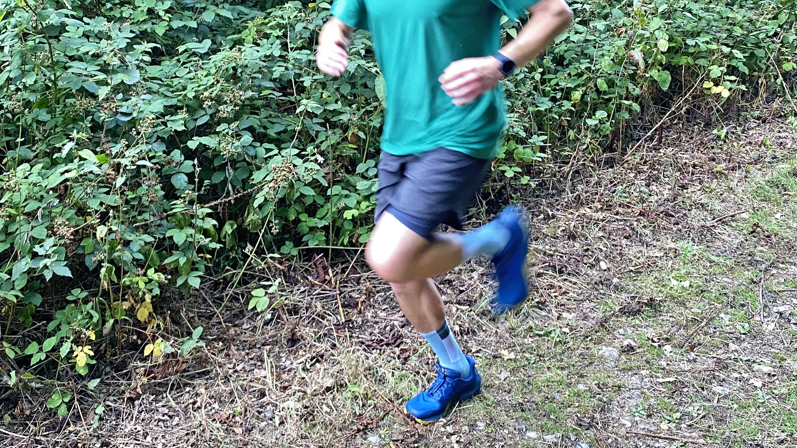 Runner on the trails in a pair of the Topo Athletic MTN Racer 4s