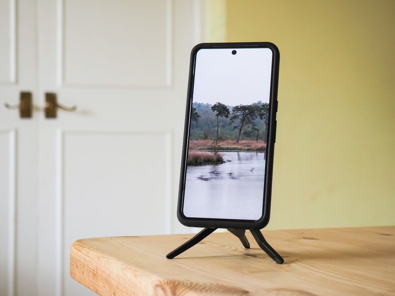 Peak Design Mobile Tripod folded away in use on a table, with a Pixel phone attached
