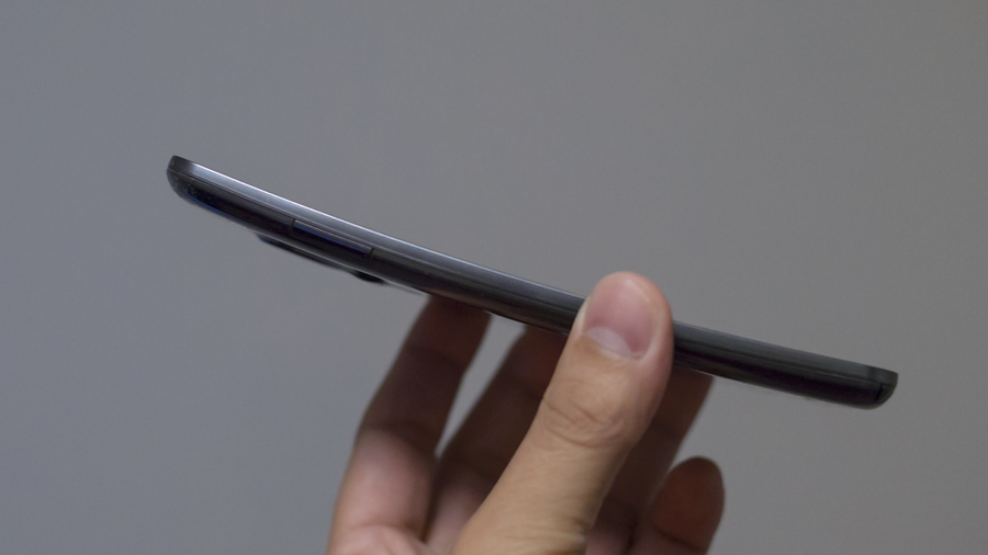A hand holding the LG G Flex phone
