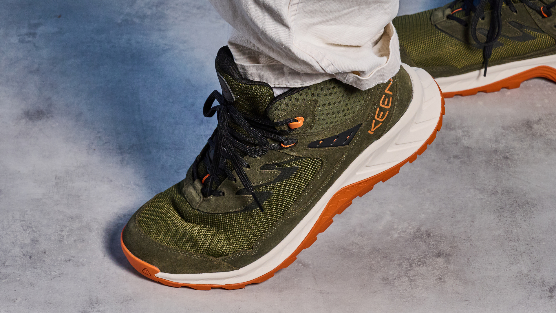The Keen Hightrail Mid boots in Green on foot, on a stone surface