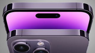The top of two iPhone 14 phones on a grey background