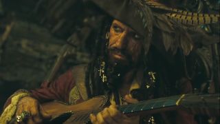 Keith Richards glances sideways while playing guitar dressed as a pirate in Pirates of the Caribbean: At World's End.
