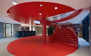 A bold red staircase sits in the centre of ArtLab’s reception