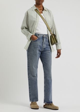 Woman wears striped shirt, blue jeans and birkenstock bostons