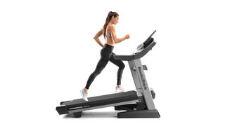NordicTrack Commercial 2950 treadmill review:: image shows woman using NordicTrack Commercial 2950 treadmill on an incline