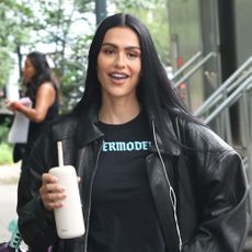 Amelia Gray Hamlin wearing a leather bomber jacket, T-shirt, low-rise jeans, and sneakers in NYC