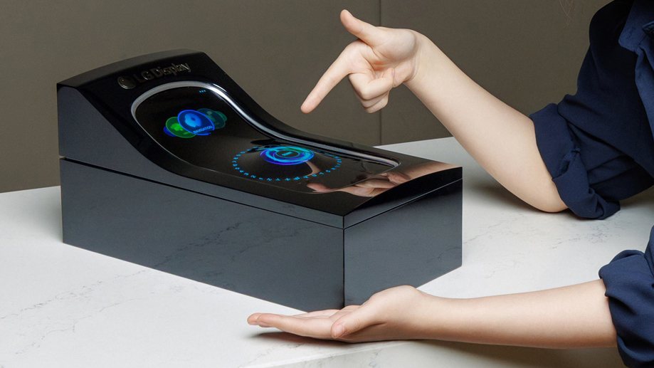 Two hands pointing at a concept LG stretchable display for cars