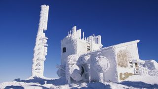 An observatory is covered with heavy snow atop Mount Washington