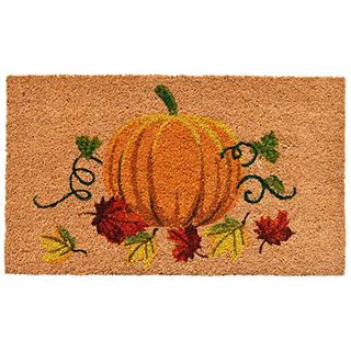 A bamboo doormat with a painted pumpkin motif 