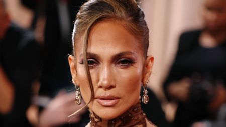 Jennifer Lopez posing in an updo at the 2026 Golden Globes 