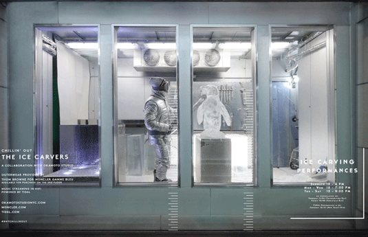 Through a window, a person in an insulated suit is seen ice carving in Barney's