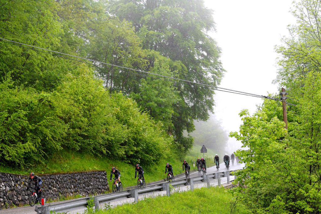 CORTINA DAMPEZZO ITALY MAY 24 The peloton passing through Farra 396 landscape during the 104th Giro dItalia 2021 Stage 16 a 153km stage shortened due to bad weather conditions from Sacile to Cortina dAmpezzo 1210m Fog Rain girodiitalia Giro on May 24 2021 in Cortina dAmpezzo Italy Photo by Tim de WaeleGetty Images