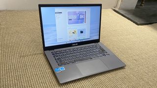 Asus Chromebook Plus laptop on a beige patterned surface