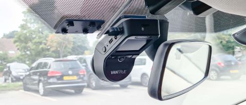 Vantrue S1 dash cam mounted in car by rearview mirror