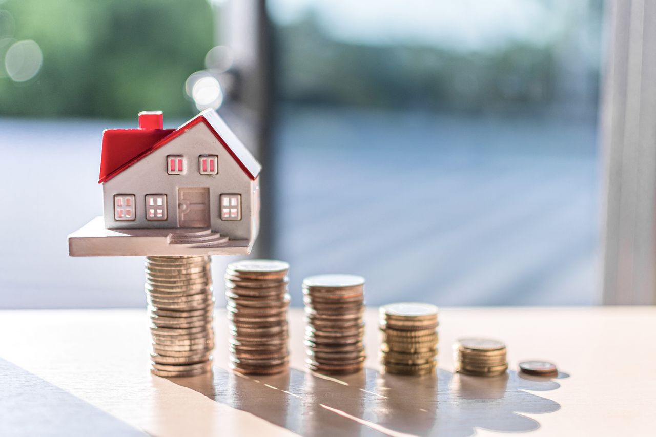 house on pile of coins