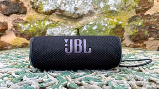 JBL Flip 6 speaker outside on garden table