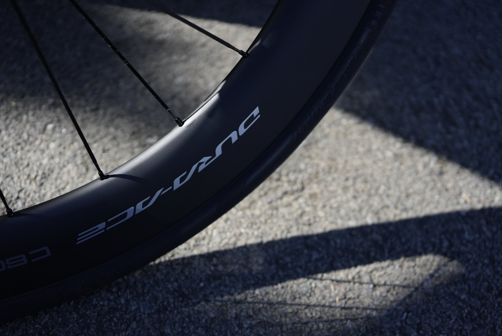 Carbon wheel showing Dura Ace decals and carbon spokes