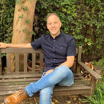 picture of kitchen designer Richard Davonport sitting on a bench