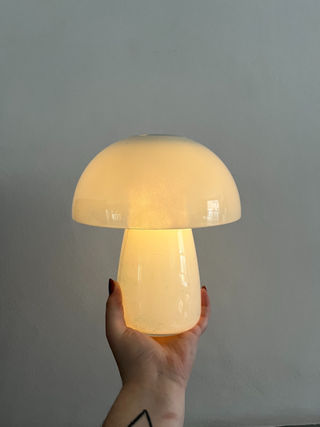 A lit up mushroom lamp