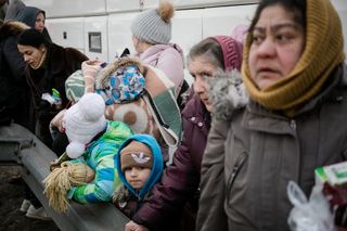 Ukrainian refugees fleeing over Polish border.