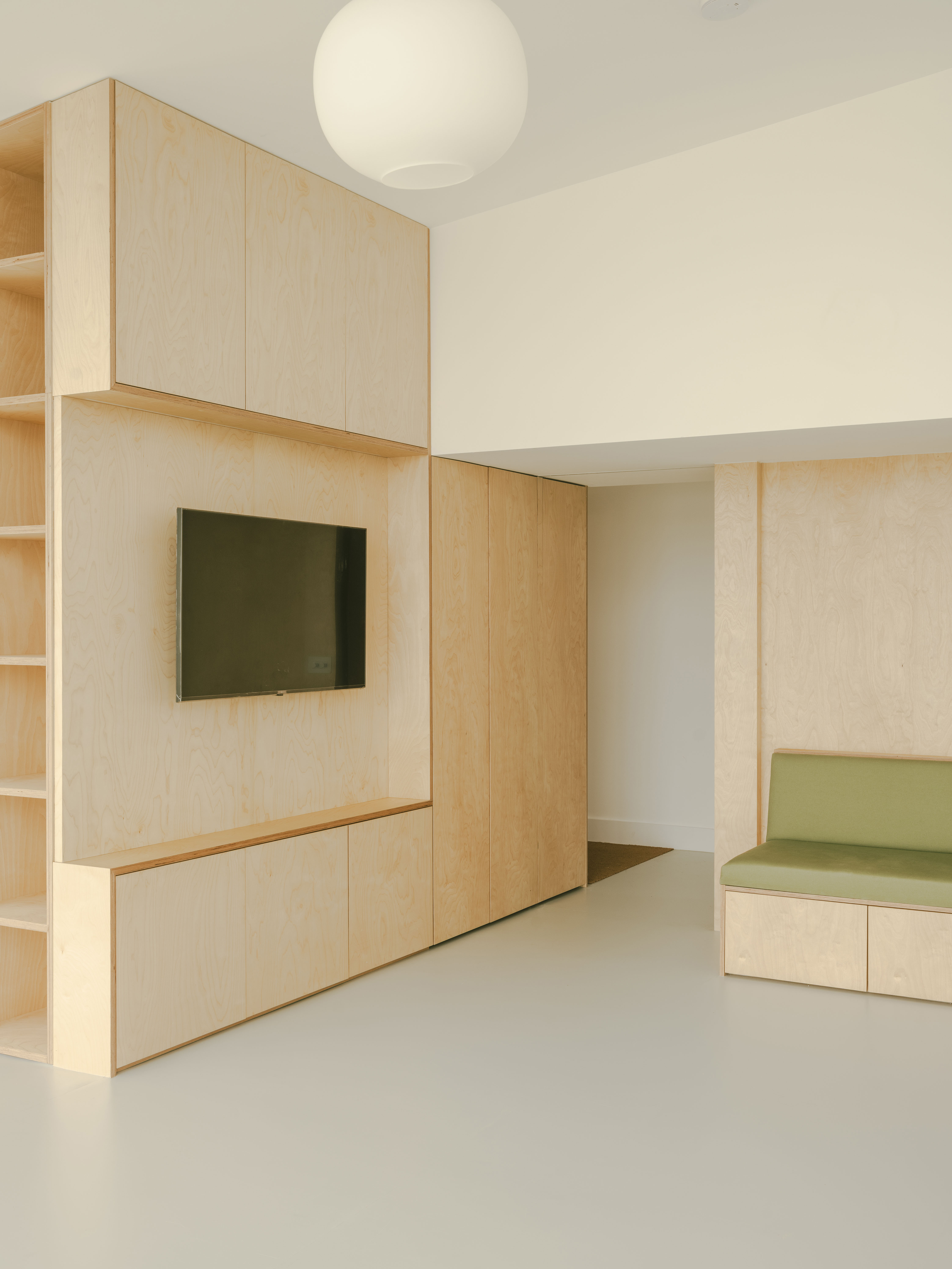 Bespoke joinery throughout the main living space creates a calm, almost gallery-like atmosphere