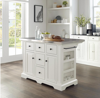an all-white kitchen with a white island