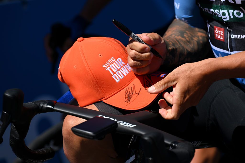 Bora-Hansgrohe rider Sam Welsford signs an autograph at the start