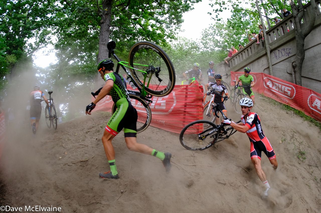 Racers make their way around a steep, dusty corner.