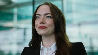Close up of Emma Stone in a power suit as CEO Michelle Fuller in Bugonia.
