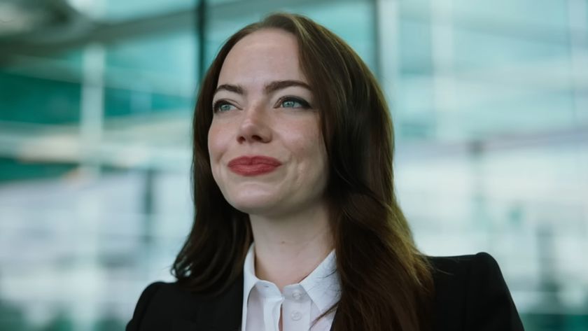 Close up of Emma Stone in a power suit as CEO Michelle Fuller in Bugonia.