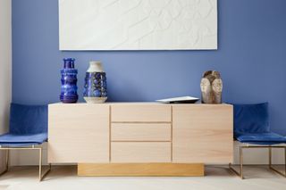 Blue monochromatic room and objects on a bedroom dresser