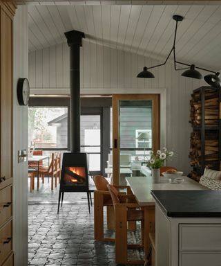 modern cottage style kitchen diner with a stone floor and paneled walls and ceiling