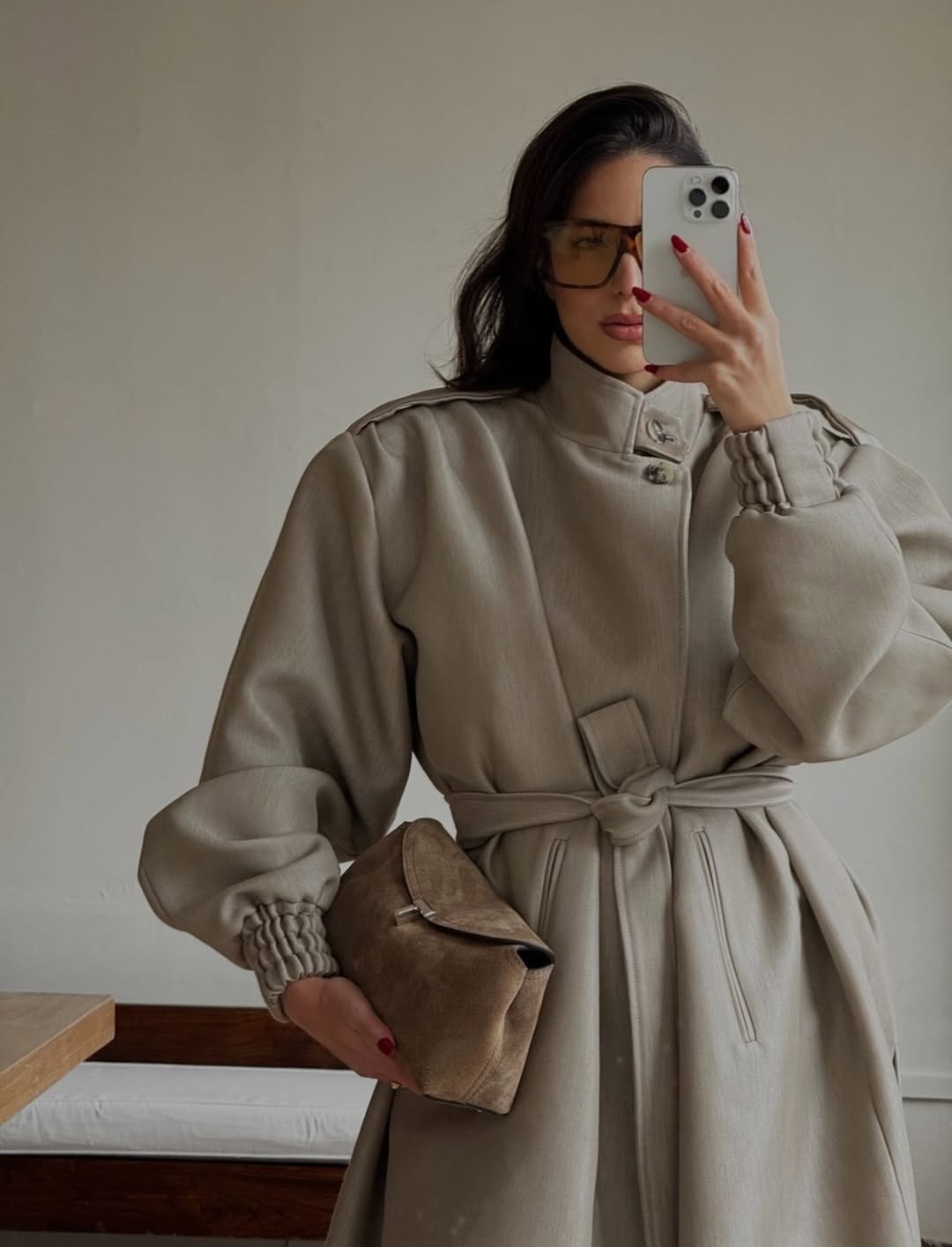 bettina looney takes a selfie wearing a cream coat