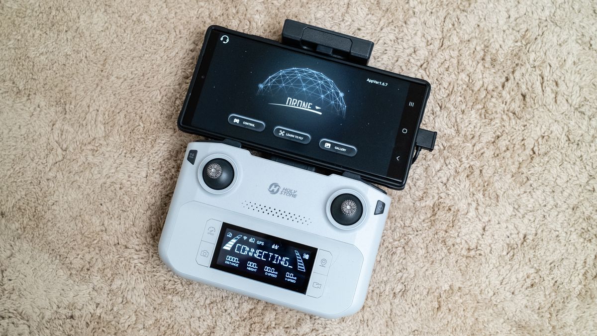 Holy Stone HS360E drone controller on a beige carpet