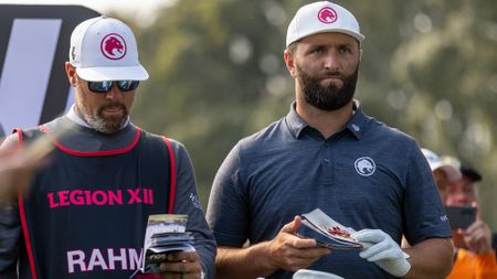 Who is Jon Rahm's Caddie? Jon Rahm with Caddie Adam Hayes on the tee at a LIV Golf Event