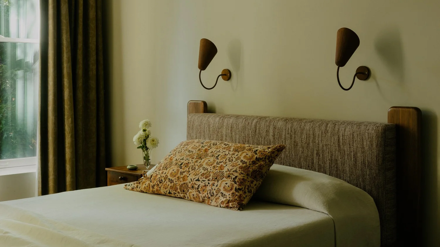 neutral bedroom with modern sconces above the bed