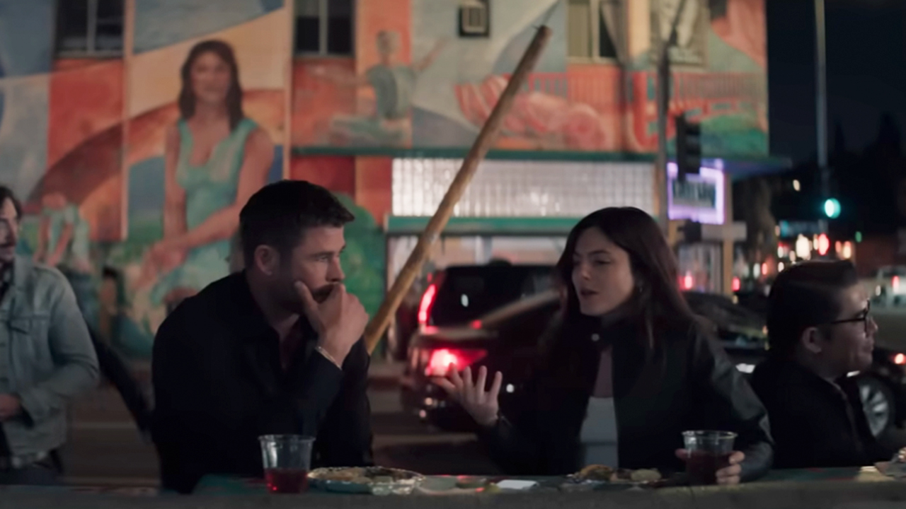 Chris Hemsworth on the left, chatting with Monica Barbaro in Crime 101