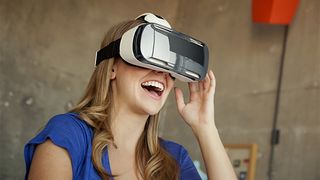 A woman wearing the Gear VR for Galaxy Note 4