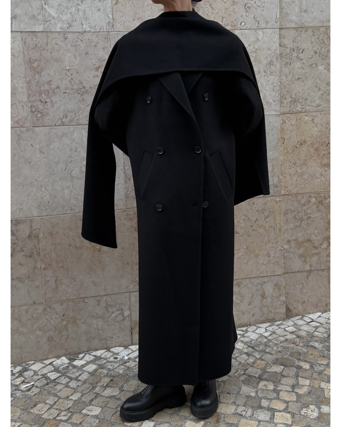 Meghan Markle wearing scarf neckline trend top in white.